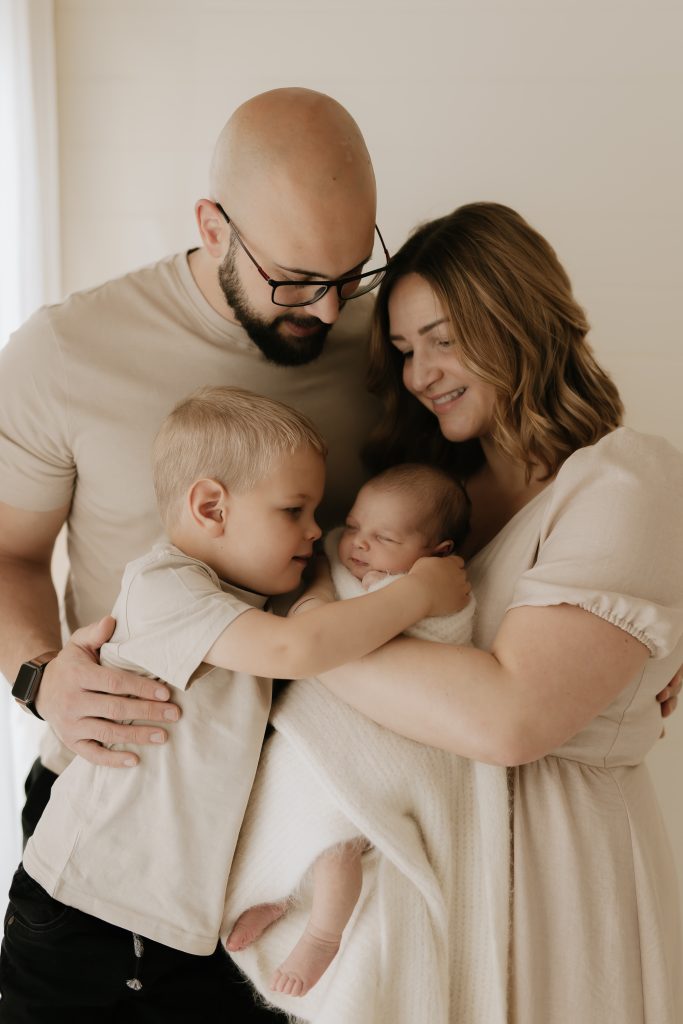 family photo with toddler and newborn